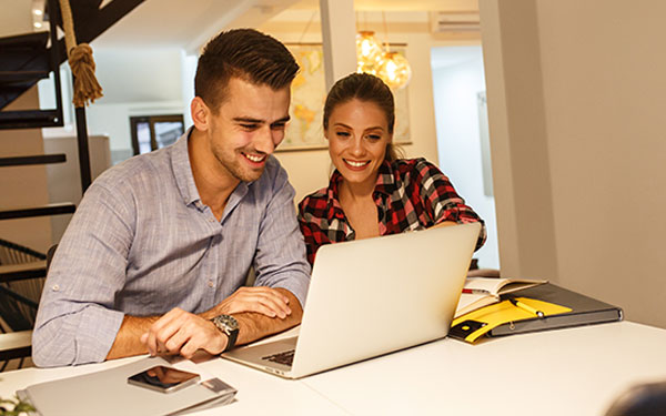 A couple working on a laptop