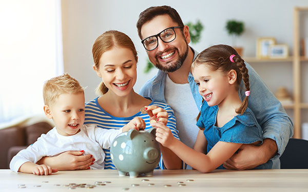 A family putting coins into a piggy bank